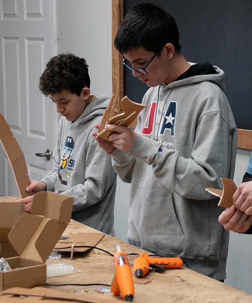 Photo of STEM students working on building Flite Test planes.